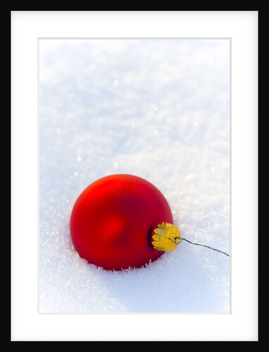 Close-up of a red Christmas bauble on snow by Anonymous