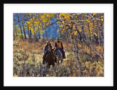 Cowgirl and cowboy riding together by Anonymous