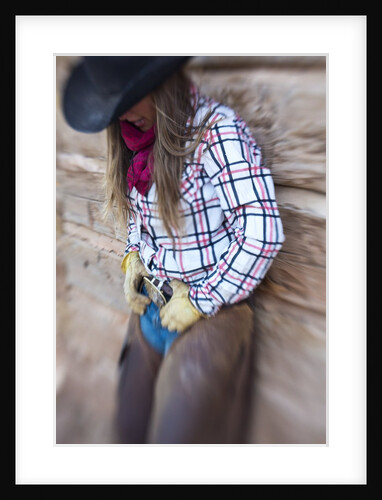 Cowgirl outside cabin by Anonymous