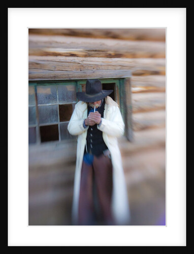 Cowboy lighting a cigarette by Anonymous