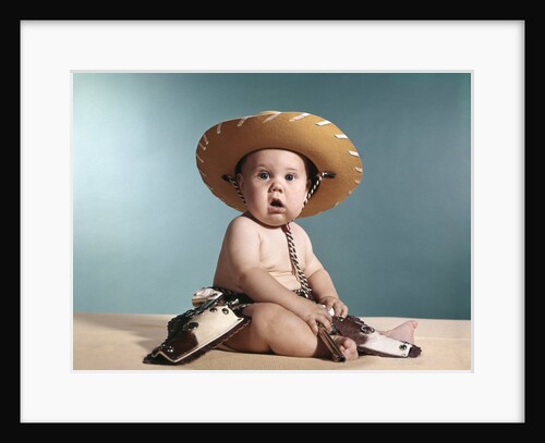 1960s Baby Wearing Cowboy Costume With Funny Facial Expression Looking At Camera by Anonymous