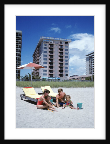 1990s Young Family On Beach Playing In The Sand by Anonymous