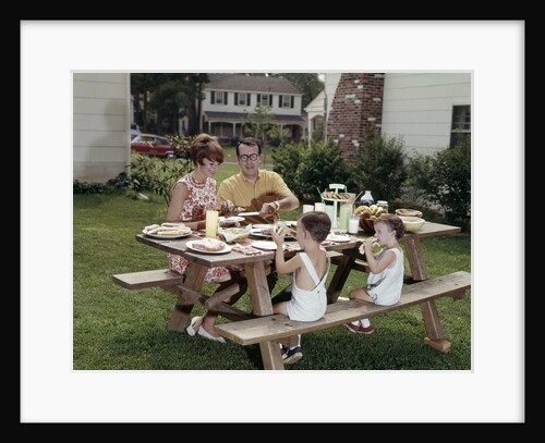 1960s Family Of Four At Backyard Picnic Table by Anonymous
