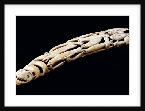 An Eskimo carved walrus ivory tusk with various spirit and animal figures by Anonymous