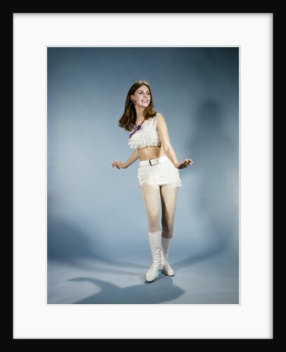 1970s Smiling Young Woman Dancing Wearing White Fringed Top Miniskirt And Go-go Boots by Anonymous