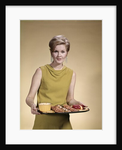 1960s Blonde Woman Looking At Camera Serving Snacks Hors d'Oeuvres On Tray by Anonymous