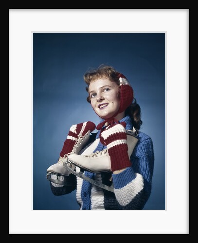 1960s Smiling Woman Wearing Red Mittens Ear Muff Blue Sweater Holding Ice Skates by Anonymous
