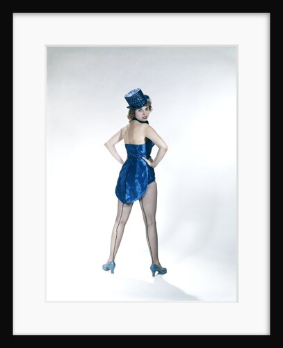 1960s Woman Looking Over Shoulder Wear Dance Costume Blue Sequined Top Hat Silk Tails Fishnet Seamed Stockings Looking At Camera by Anonymous