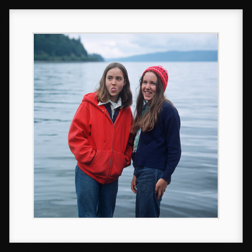 two Teenaged Girls Standing By Lake by Anonymous