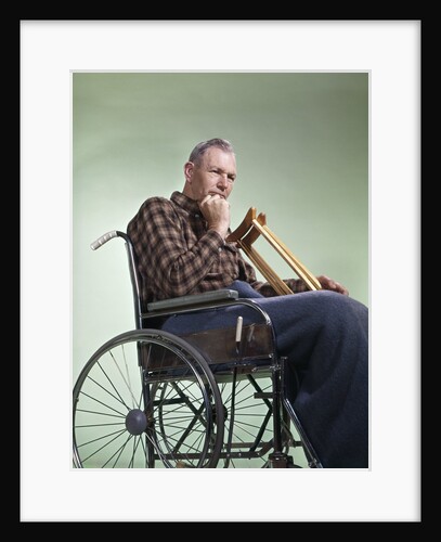 1960 1960s Retro Senior Man Sitting In Wheelchair With Crutches Blanket Wrapped Around Legs by Anonymous