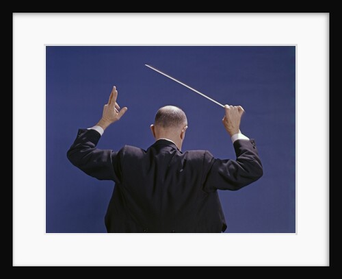 1950s 1960s 1970s View Of Back Of Bald Man Conducting A Symphony Orchestra by Anonymous