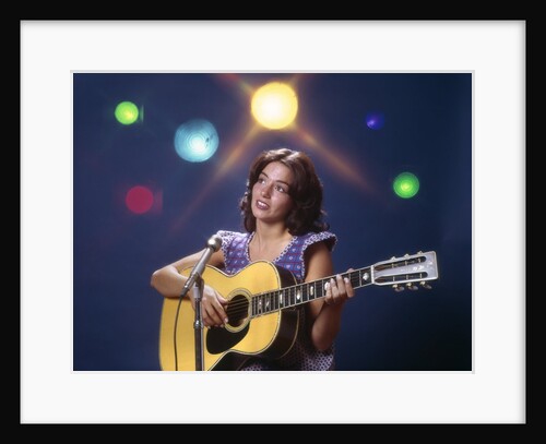1970s Woman Girl Performer Playing Guitar Singing Microphone Stage Lights by Anonymous