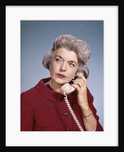 1960s Senior Middle Aged Woman Red Blouse Serious Expression Talking On Telephone by Anonymous