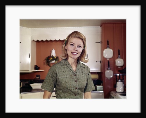 1960s Portrait Young Blonde Woman Housewife In Kitchen Smiling Looking At Camera by Anonymous