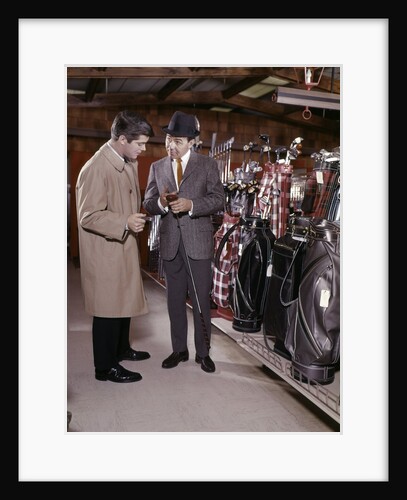 1960s Two Men In Golf Equipment Shop Talking And Discussing Purchase Of A Driver Golf Club by Anonymous