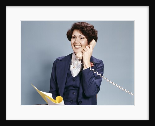 1970s Smiling Woman Wearing A Business Suit Talking On Telephone by Anonymous