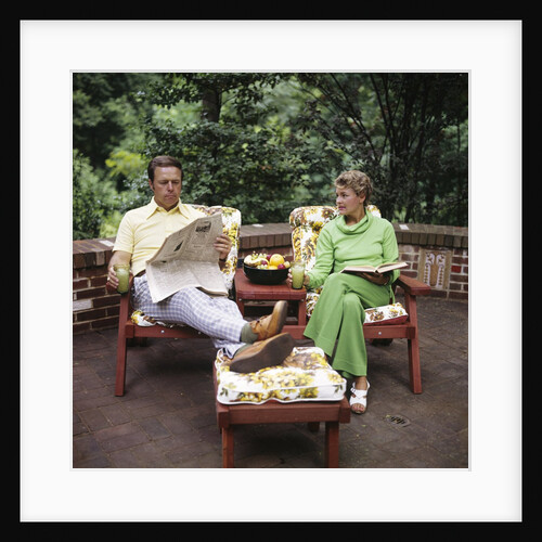 1970s Couple Man Woman Middle Aged Sitting Patio Deck Reading Book Newspaper Retro by Anonymous