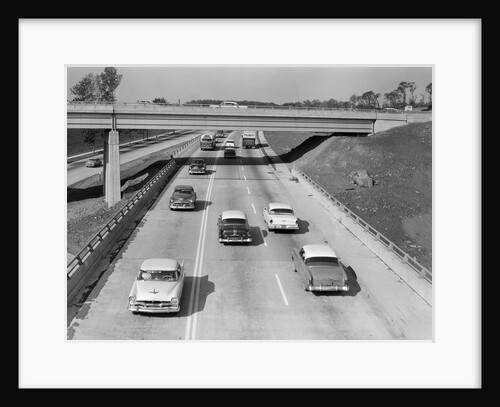 1950s Cars Automobiles Driving On Highway Under Overpass by Anonymous