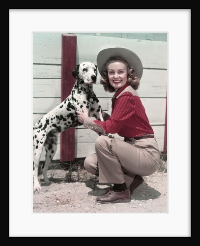 1940s 1950s Smiling Woman Wearing Western Cowgirl Outfit Kneeling Petting Dalmatian Dog by Anonymous