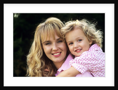 1990s Portrait Of Mother And Daughter Outdoors Looking At Camera Wearing Pink Shirts by Anonymous