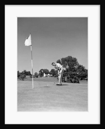 1950s Man Playing Golf Putting Golf Ball On Green To Flag And Cup Outdoor by Anonymous