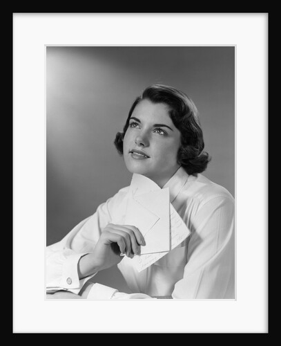 1950s Teenage Girl Reading A Letter And Dreaming A Daydream by Anonymous