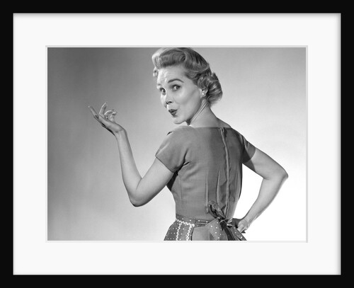 1950s Housewife Woman Wearing Apron Whistling In Surprise Pointing Hand Studio by Anonymous