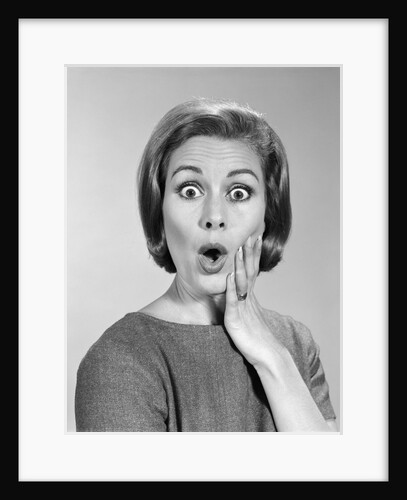 1960s Portrait Woman With Hand On Cheek Looking At Camera With Shocked Expression by Anonymous