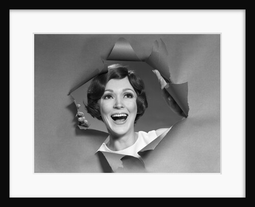 1960s 1970s Portrait Of Smiling Woman Looking Through A Hole Torn In Paper by Anonymous