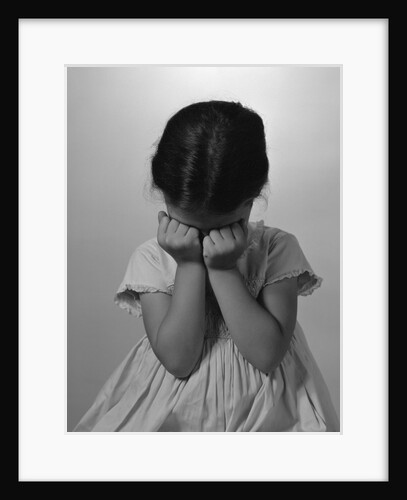 1960s Sad Little Girl Sitting Hands On Face Crying by Anonymous