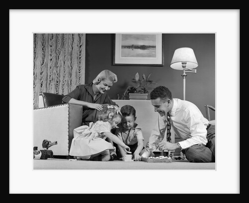 1950s Family Of 4 Gathered In Living Room Playing With Letter Blocks by Anonymous