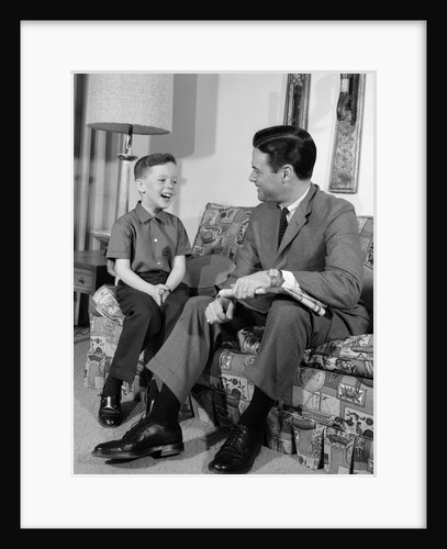 1960s Boy Sitting On Couch Smiling Laughing Talking With Dad by Anonymous