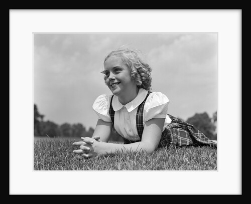 1940s Blond Girl Smiling Lying On Grass by Anonymous