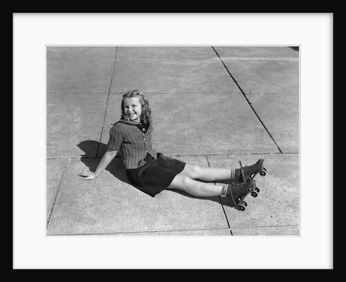 1940s Little Girl Fallen Sitting On Ground Wearing Roller-skates Looking At Camera by Anonymous
