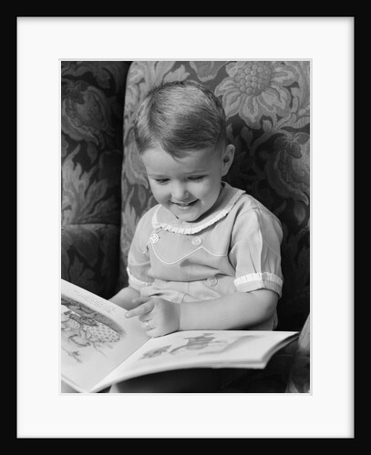 1930s 1940s Little Boy Sitting On Chair Reading Picture Book by Anonymous
