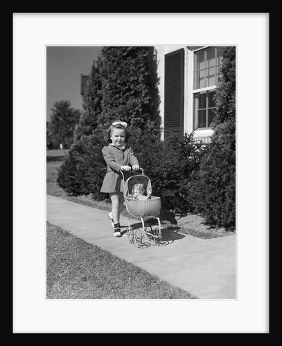 1940s Little Girl Walking Pushing Her Doll In Antique Woven Wicker Stroller Looking At Camera On Sidewalk In Front Of House by Anonymous