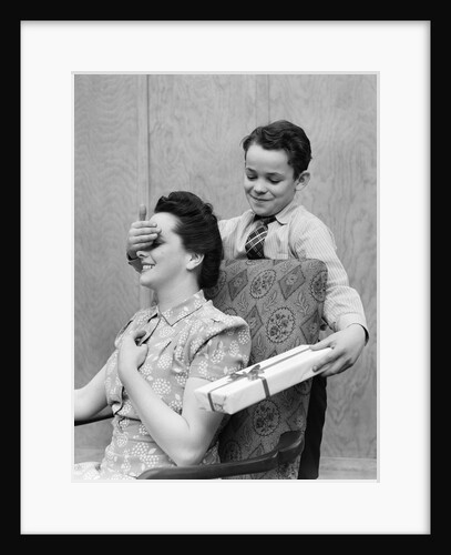 1930s 1940s Boy Son Surprising Woman Mother With Gift Wrapped Present by Anonymous