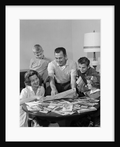 1960s Happy Family Father Mother Two Sons One Daughter Planning Trip Looking At Maps by Anonymous