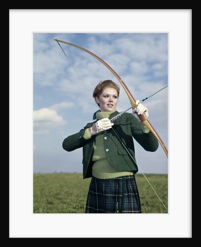 1960s 1970s Sports Woman Archer Holding Bow Preparing To Draw Arrow by Anonymous