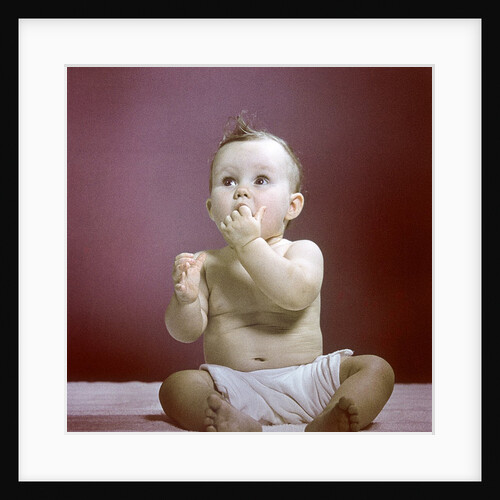 1940s 1950s Baby Diaper Sitting Looking Up Fingers In Mouth by Anonymous