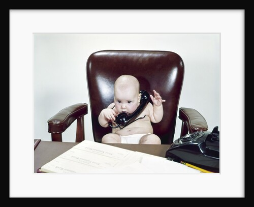 1960s Chubby Baby Sitting In Leather Office Chair Behind Desk Holding Talking On Telephone by Anonymous
