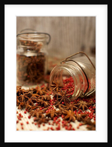 Star anise and red pepper corns around a rustic mason jar by Anonymous
