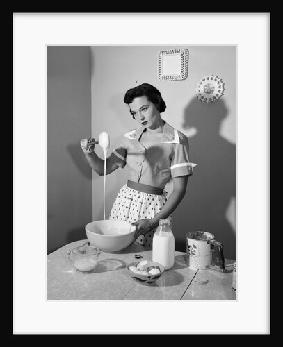 1950s housewife mixing sticky batter in kitchen by Anonymous