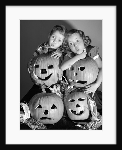1950s boy and girl with four jack-o-lanterns by Anonymous