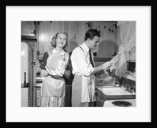 1950s smiling couple washing the dishes together by Anonymous