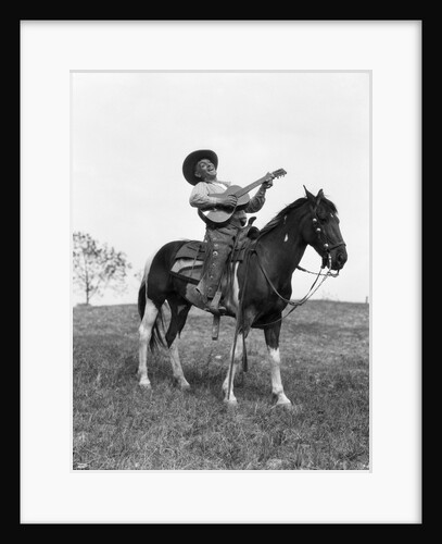 1920s cowboy on horse singing and playing guitar by Anonymous