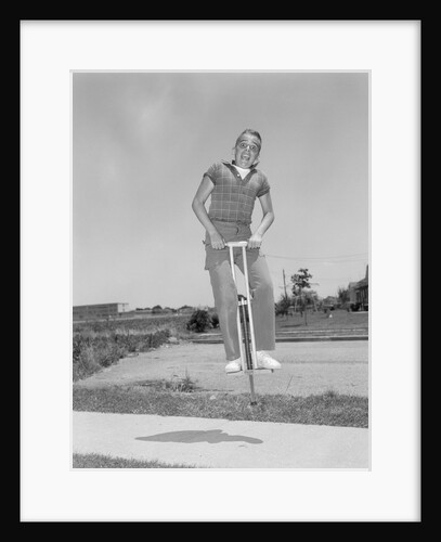 1950s boy jumping on pogo stick by Anonymous