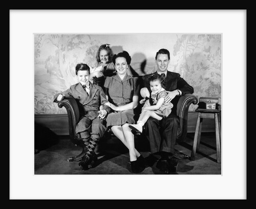 1930s 1940s family of five on a couch by Anonymous