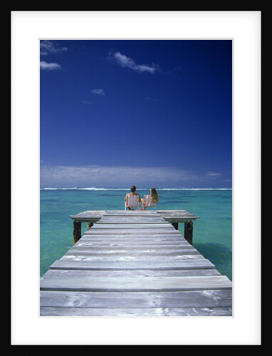 couple Sitting On A Pier In An Ocean Lagoon by Anonymous