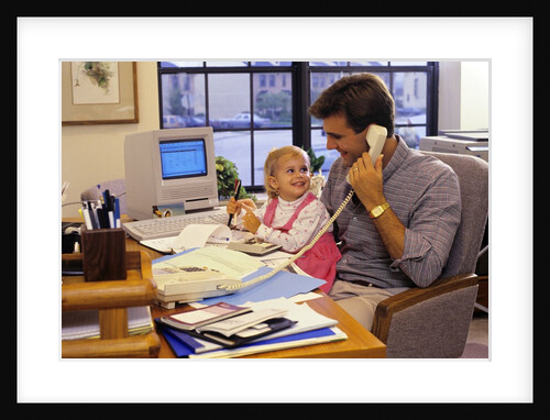 Father with young daughter in home office by Anonymous